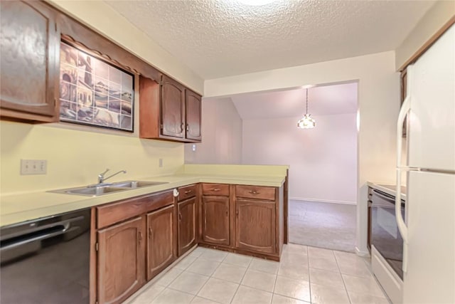 2008 Sandberg Dr, Austin, TX 78752 - kitchen featuring dishwasher, range, freestanding refrigerator, a peninsula, and light countertops