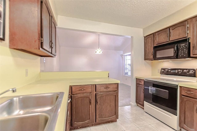 2008 Sandberg Dr, Austin, TX 78752 - kitchen with white electric range oven, black microwave, light countertops, a peninsula, and a textured ceiling
