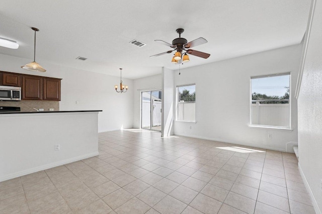 1900 Little Elm Trl Unit 98, Cedar Park, TX 78613 - unfurnished living room featuring a chandelier, ceiling fan, and light tile patterned floors