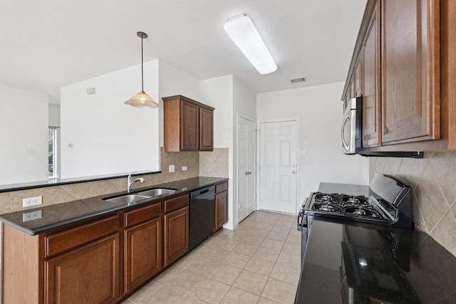 1900 Little Elm Trl Unit 98, Cedar Park, TX 78613 - kitchen with appliances with stainless steel finishes, tasteful backsplash, a peninsula, and light tile patterned flooring