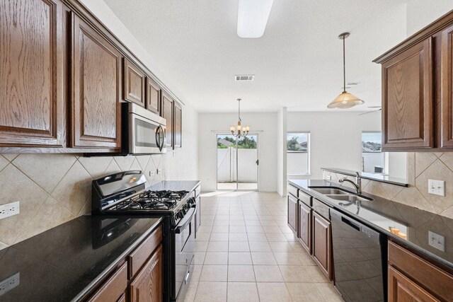 1900 Little Elm Trl Unit 98, Cedar Park, TX 78613 - kitchen featuring gas stove, dishwashing machine, stainless steel microwave, dark countertops, and backsplash