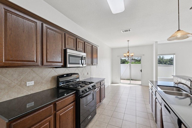 1900 Little Elm Trl Unit 98, Cedar Park, TX 78613 - kitchen featuring stainless steel appliances, decorative backsplash, a chandelier, and hanging light fixtures