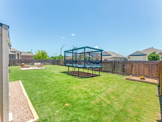 1329 Nokota Bnd, Georgetown, TX 78626 - fenced backyard featuring a trampoline, an outdoor hangout area, and a patio area