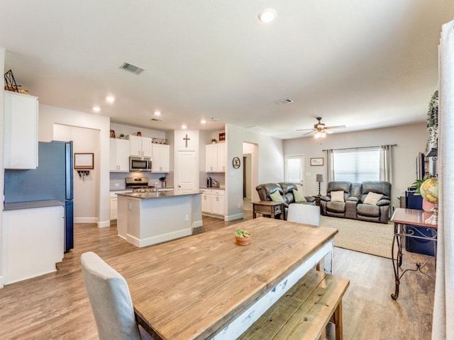 1329 Nokota Bnd, Georgetown, TX 78626 - dining area featuring light wood finished floors, ceiling fan, and recessed lighting