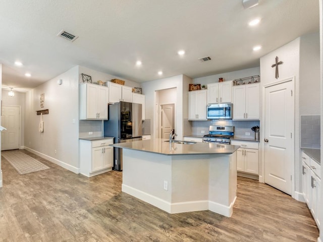 1329 Nokota Bnd, Georgetown, TX 78626 - kitchen with stainless steel appliances, recessed lighting, backsplash, light wood-type flooring, and white cabinets