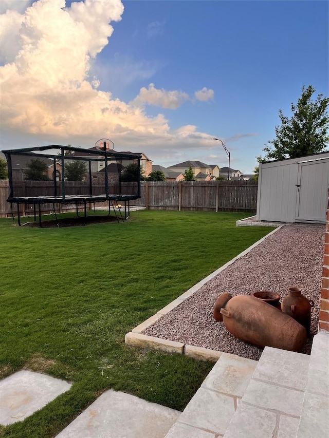 1329 Nokota Bnd, Georgetown, TX 78626 - fenced backyard with a trampoline