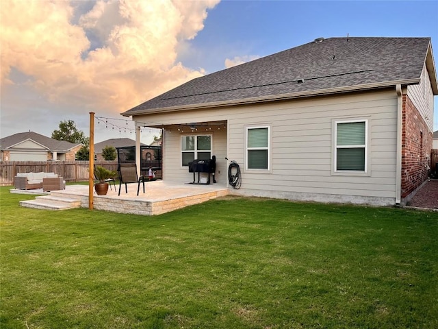 1329 Nokota Bnd, Georgetown, TX 78626 - rear view of property featuring an outdoor hangout area, a patio area, a fenced backyard, and a shingled roof