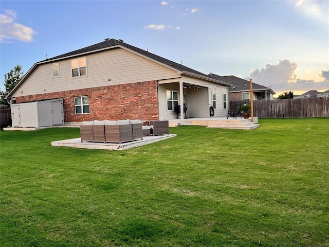 1329 Nokota Bnd, Georgetown, TX 78626 - back of property with a patio, brick siding, a fenced backyard, and outdoor lounge area