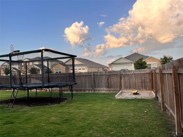 1329 Nokota Bnd, Georgetown, TX 78626 - fenced backyard with a trampoline
