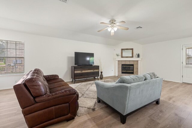 1643 Abbey Ln, Cedar Park, TX 78613 - living room featuring ceiling fan, light wood-style floors, a tiled fireplace, and lofted ceiling
