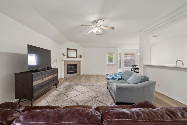 1643 Abbey Ln, Cedar Park, TX 78613 - living room featuring ceiling fan, wood finished floors, a tiled fireplace, and lofted ceiling