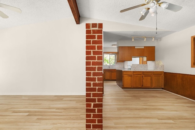 6804 Miranda Dr, Austin, TX 78752 - kitchen featuring brown cabinetry, ceiling fan, light wood-style flooring, a textured ceiling, and light countertops
