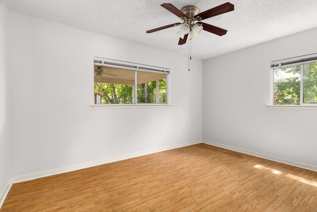 6804 Miranda Dr, Austin, TX 78752 - empty room featuring wood finished floors, a textured ceiling, and ceiling fan