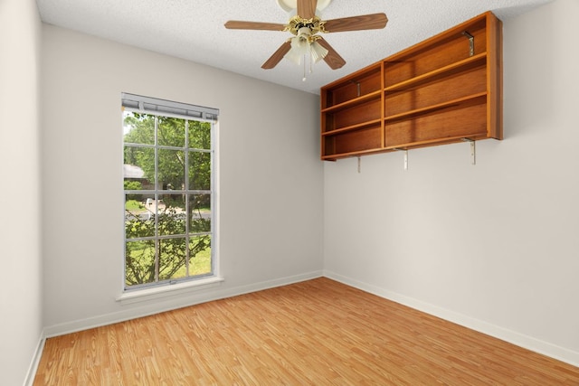 6804 Miranda Dr, Austin, TX 78752 - empty room featuring wood finished floors, ceiling fan, and a textured ceiling