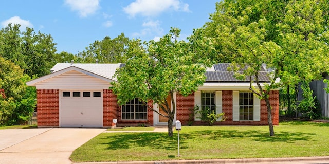 6804 Miranda Dr, Austin, TX 78752 - view of front of property with brick siding, concrete driveway, roof mounted solar panels, and a garage