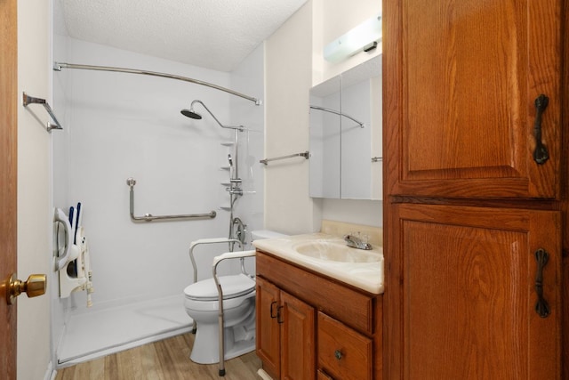 6804 Miranda Dr, Austin, TX 78752 - full bath with a shower, vanity, wood finished floors, and a textured ceiling