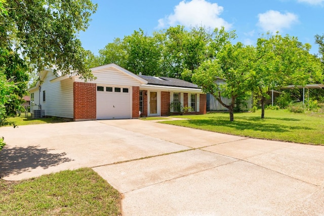 6804 Miranda Dr, Austin, TX 78752 - ranch-style house with an attached garage, brick siding, driveway, a front lawn, and roof mounted solar panels