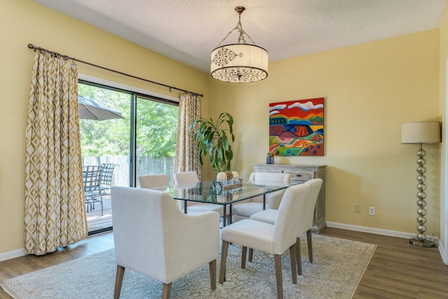 5808 Abilene Trl, Austin, TX 78749 - dining space with wood finished floors, a chandelier, and a textured ceiling