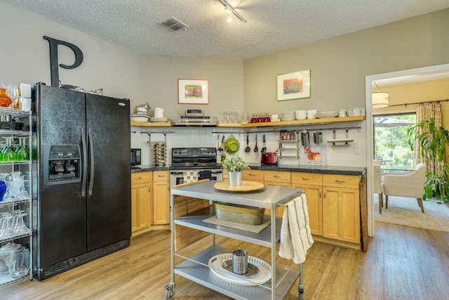 5808 Abilene Trl, Austin, TX 78749 - kitchen with open shelves, black refrigerator with ice dispenser, light wood finished floors, dark countertops, and a textured ceiling