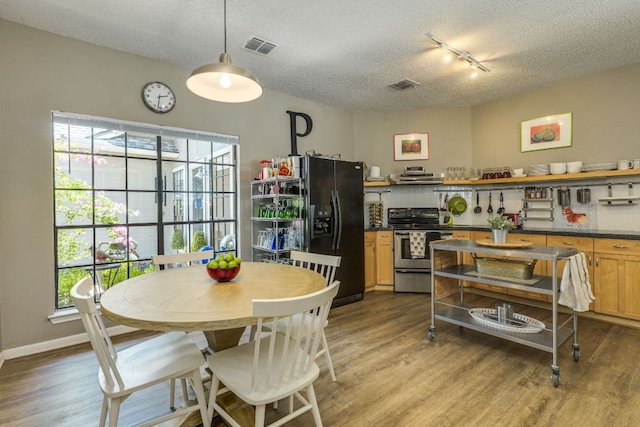 5808 Abilene Trl, Austin, TX 78749 - dining room with wood finished floors, a textured ceiling, and plenty of natural light