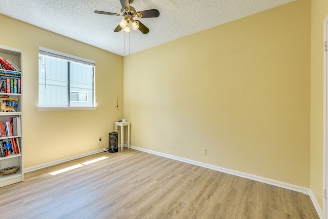 5808 Abilene Trl, Austin, TX 78749 - spare room featuring light wood-type flooring, ceiling fan, and a textured ceiling