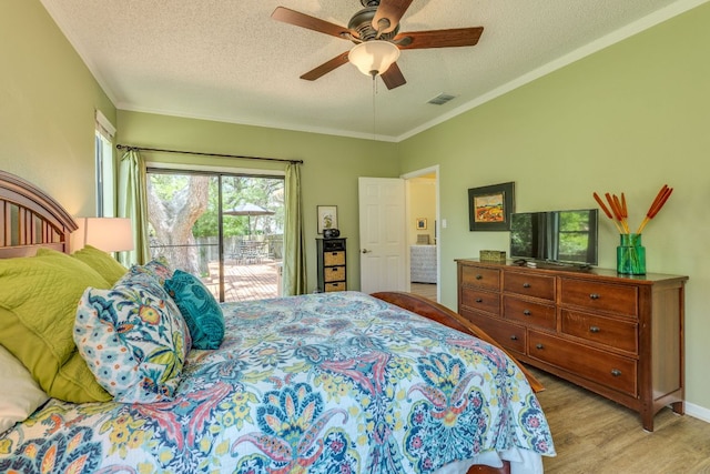 5808 Abilene Trl, Austin, TX 78749 - bedroom featuring access to exterior, wood finished floors, a textured ceiling, ceiling fan, and crown molding