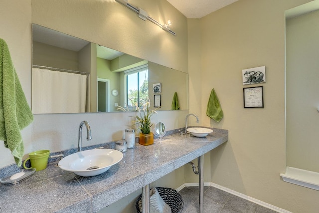 5808 Abilene Trl, Austin, TX 78749 - full bathroom with baseboards and double vanity