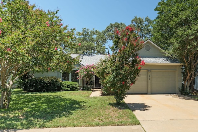 5808 Abilene Trl, Austin, TX 78749 - view of property hidden behind natural elements featuring an attached garage, concrete driveway, a front yard, and roof with shingles