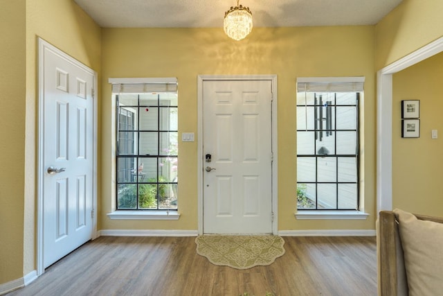 5808 Abilene Trl, Austin, TX 78749 - entrance foyer with wood finished floors and a chandelier