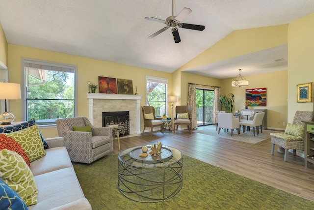 5808 Abilene Trl, Austin, TX 78749 - living area featuring wood finished floors, a tile fireplace, a ceiling fan, and lofted ceiling