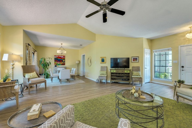 5808 Abilene Trl, Austin, TX 78749 - living area with wood finished floors, vaulted ceiling, ceiling fan, and a chandelier