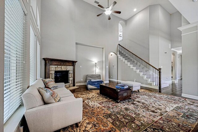 318 Gaspar Bnd, Cedar Park, TX 78613 - living area featuring a high ceiling, wood finished floors, stairway, a ceiling fan, and a stone fireplace