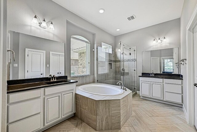 318 Gaspar Bnd, Cedar Park, TX 78613 - full bath featuring a shower stall, two vanities, a garden tub, and recessed lighting
