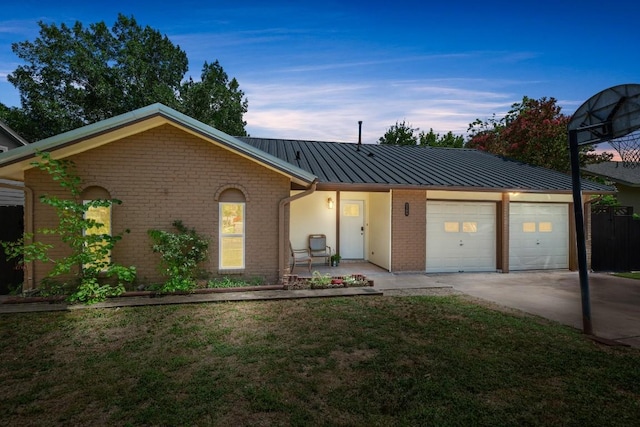 2109 Brandywine Ln, Austin, TX 78727 - ranch-style house with a garage, brick siding, a metal roof, a front lawn, and concrete driveway