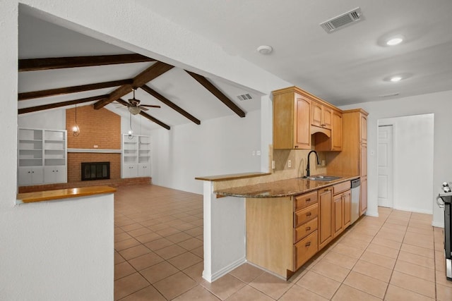 2109 Brandywine Ln, Austin, TX 78727 - kitchen featuring light tile patterned floors, dishwasher, a ceiling fan, recessed lighting, and a brick fireplace
