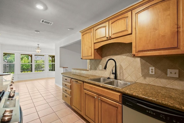 2109 Brandywine Ln, Austin, TX 78727 - kitchen with stainless steel dishwasher, light tile patterned floors, decorative backsplash, and brown cabinetry
