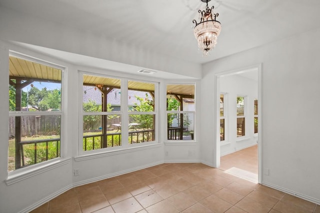 2109 Brandywine Ln, Austin, TX 78727 - unfurnished sunroom featuring plenty of natural light, tile patterned floors, and a chandelier