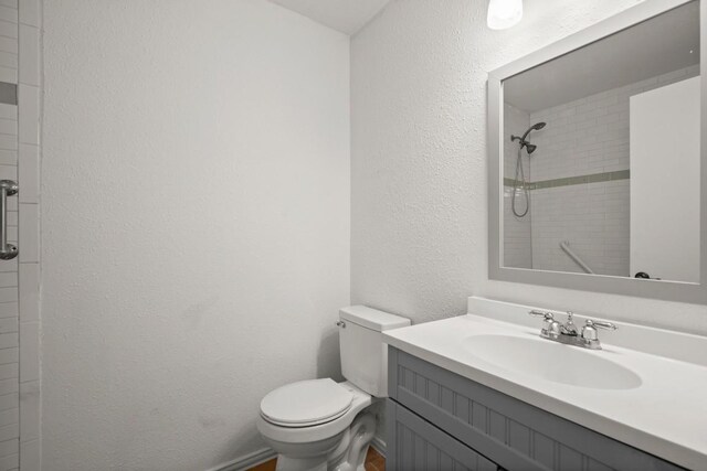 2109 Brandywine Ln, Austin, TX 78727 - bathroom featuring vanity, tiled shower, and a textured wall