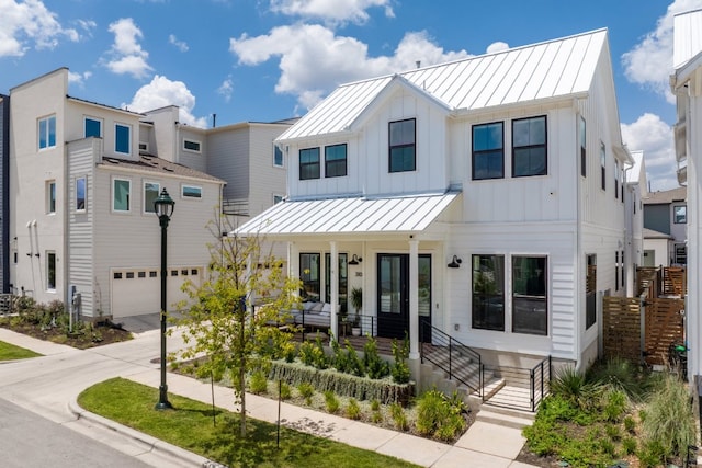 3108 Chennault St, Austin, TX 78723 - modern inspired farmhouse featuring a porch, a standing seam roof, an attached garage, concrete driveway, and board and batten siding
