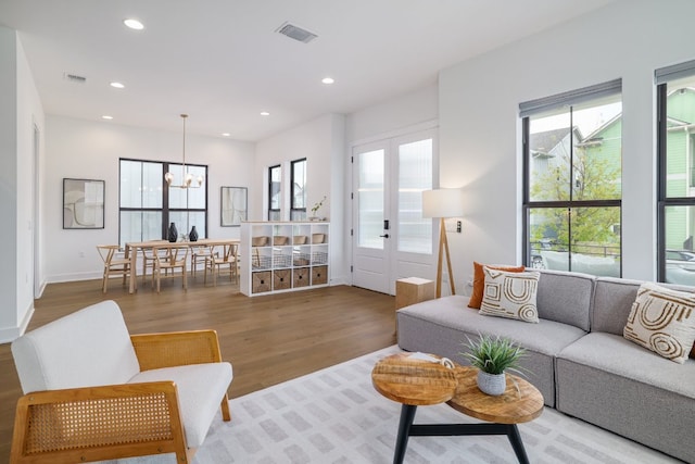 3108 Chennault St, Austin, TX 78723 - living room featuring a chandelier, wood finished floors, healthy amount of natural light, and recessed lighting