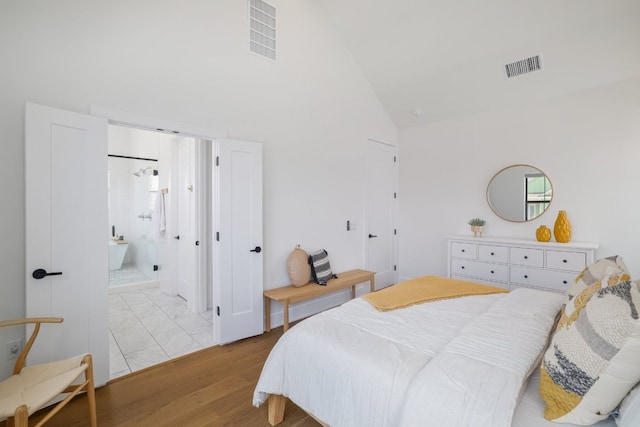 3108 Chennault St, Austin, TX 78723 - bedroom featuring high vaulted ceiling, light wood-style floors, and ensuite bath