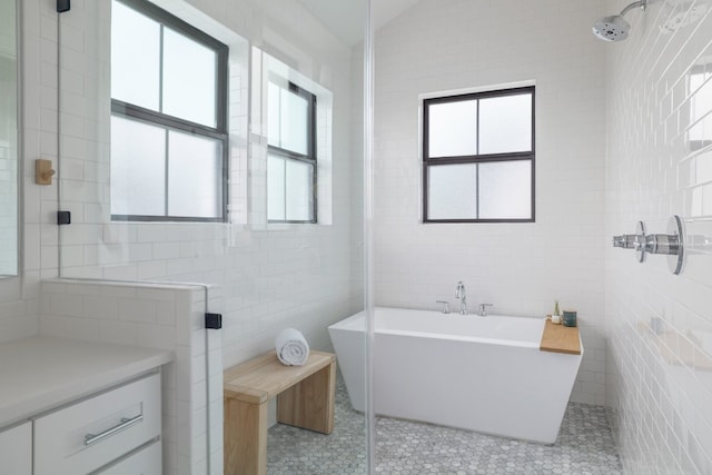 3108 Chennault St, Austin, TX 78723 - bathroom with tile walls, a soaking tub, tile patterned flooring, and tiled shower