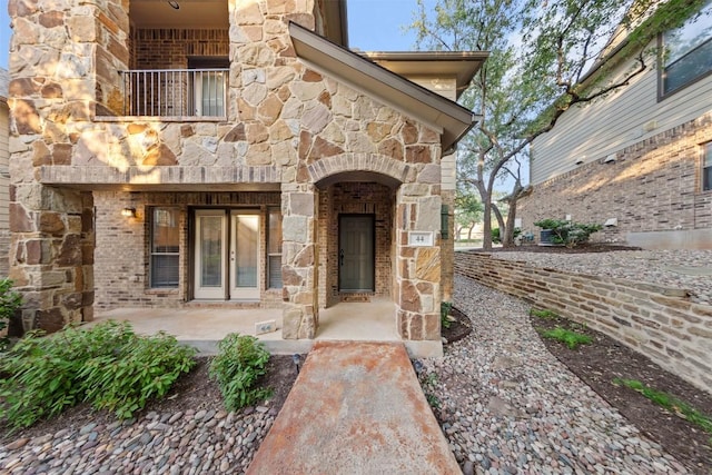 11400 W Parmer Ln Unit 44, Cedar Park, TX 78613 - view of exterior entry featuring stone siding, brick siding, and a balcony