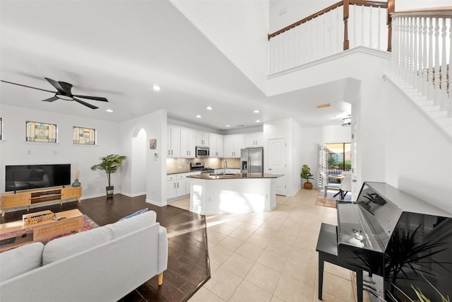11400 W Parmer Ln Unit 44, Cedar Park, TX 78613 - living room with a ceiling fan, recessed lighting, arched walkways, stairs, and light tile patterned floors