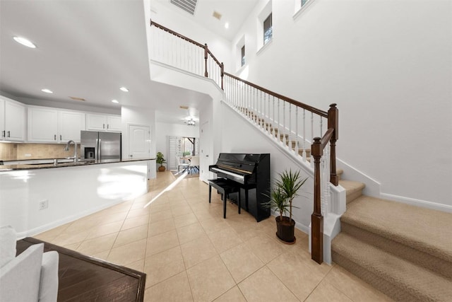 11400 W Parmer Ln Unit 44, Cedar Park, TX 78613 - living room with stairs, light tile patterned floors, recessed lighting, and a high ceiling