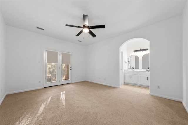 11400 W Parmer Ln Unit 44, Cedar Park, TX 78613 - spare room featuring light carpet, a ceiling fan, and arched walkways