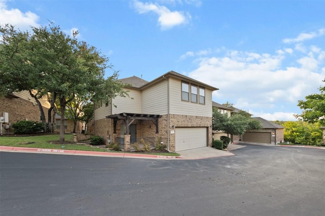 11400 W Parmer Ln Unit 44, Cedar Park, TX 78613 - view of front of house with a garage, brick siding, and a pergola
