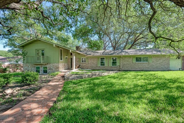 2505 Linwood Rd, Temple, TX 76502 - view of front of property featuring stone siding, a chimney, and a front yard