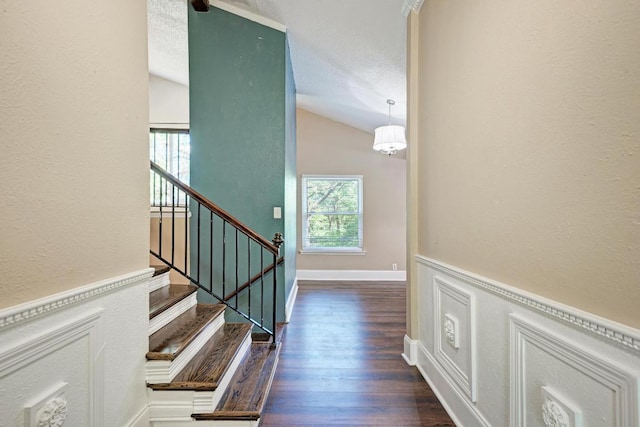2505 Linwood Rd, Temple, TX 76502 - stairs featuring wood finished floors, a textured wall, and vaulted ceiling