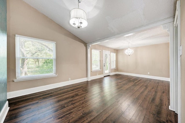 2505 Linwood Rd, Temple, TX 76502 - unfurnished room featuring a chandelier, dark wood-type flooring, a textured ceiling, and lofted ceiling